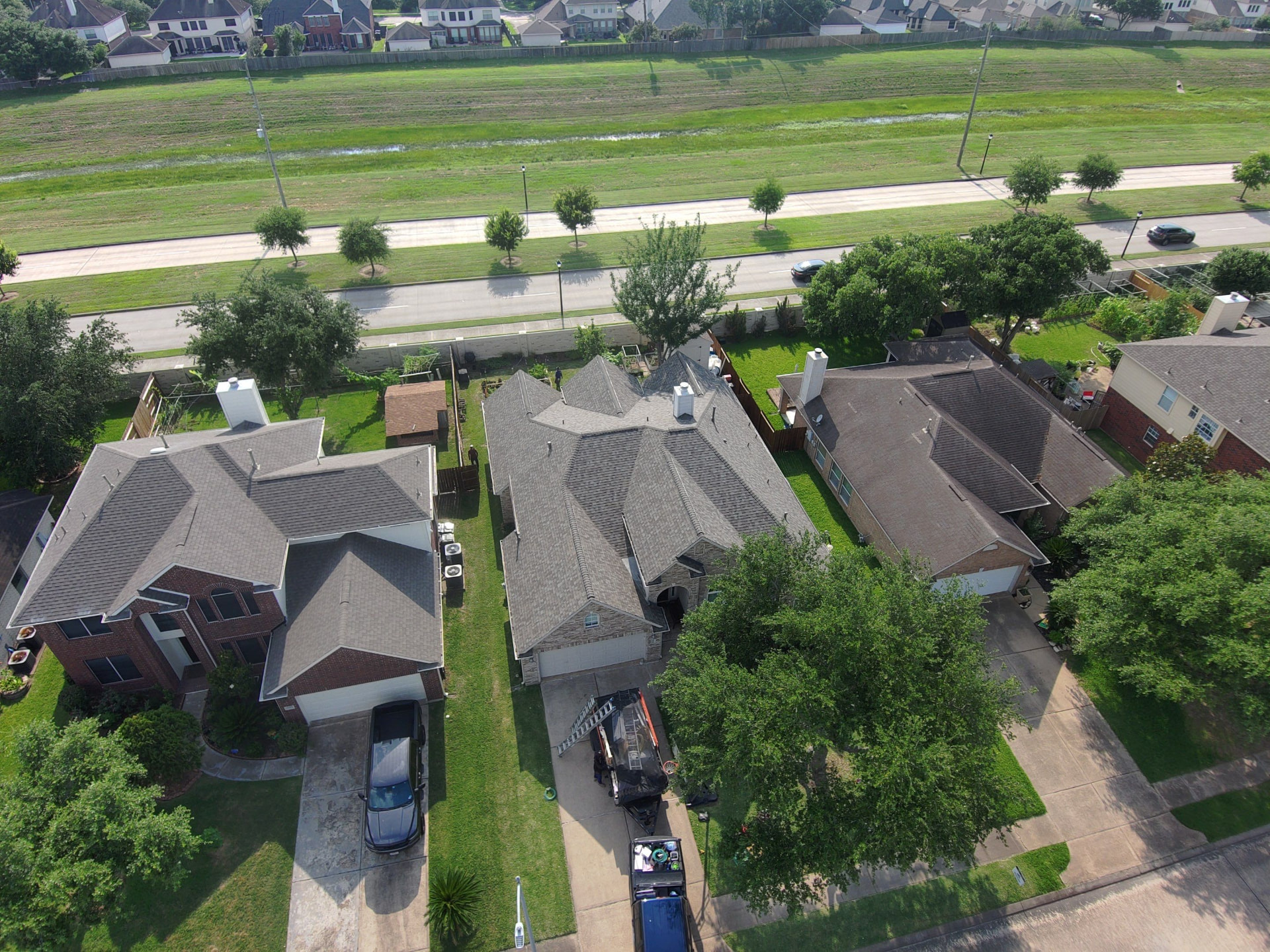 Aerial drone photo of completed roofs on a Houston-area residential street