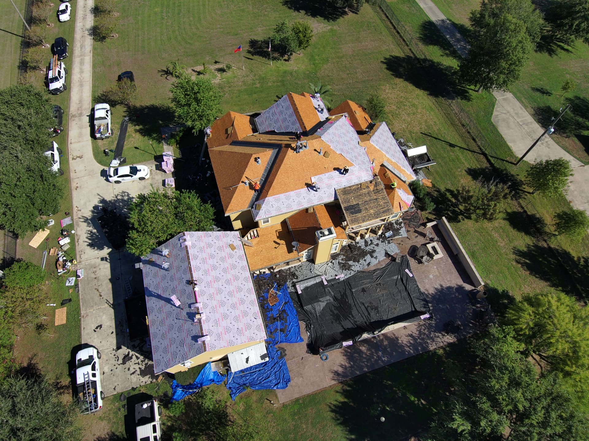 Drone photo of underlayment installed over new decking on a two-story home